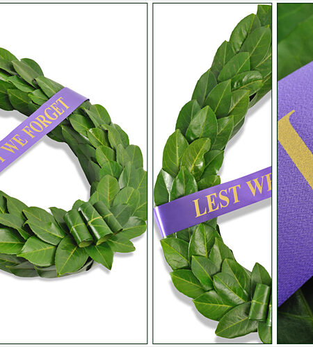 Traditional laurel leaf wreath with Lest We Forget ribbon across