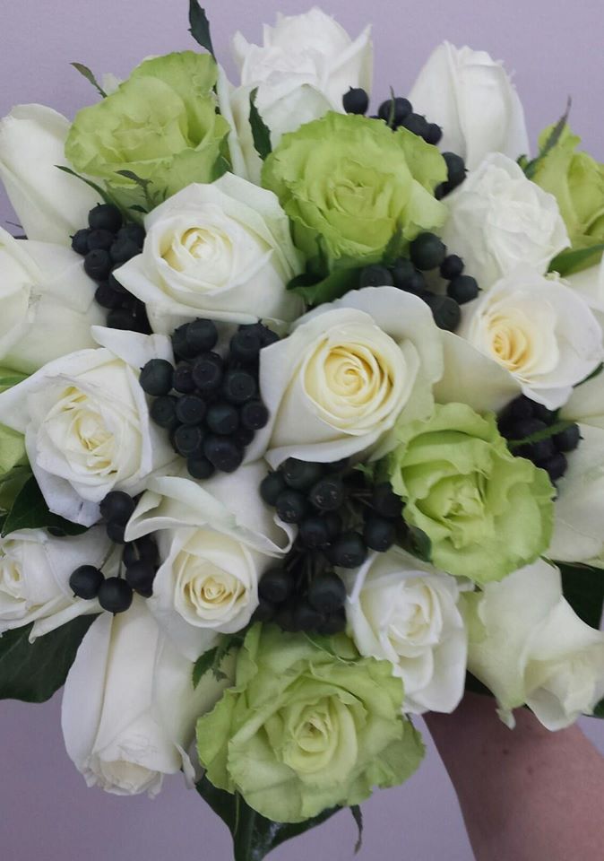 green and white roses with berries