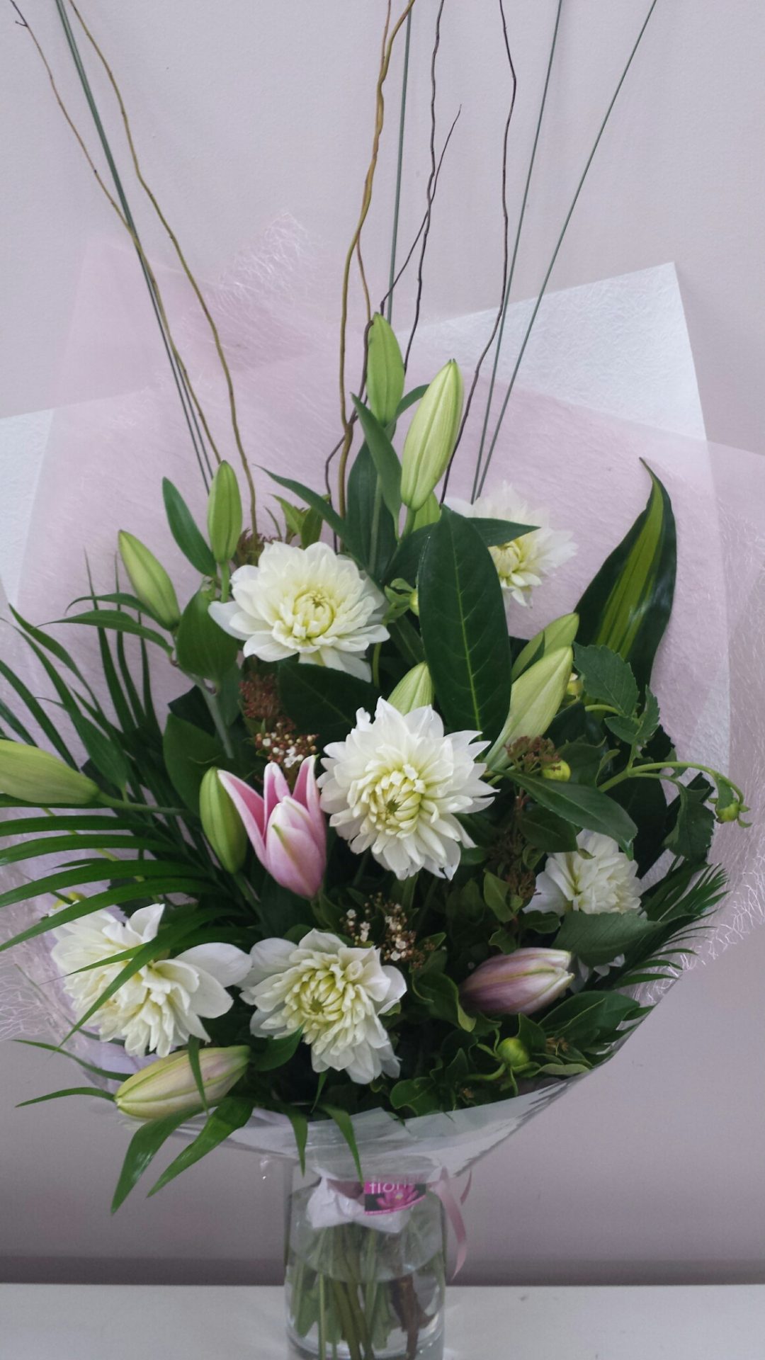 aduation bouquet lilies and dahlias with tropical foliages