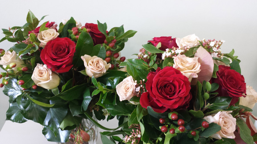 Red and Honeymoon roses with hypericum berries and foliage
