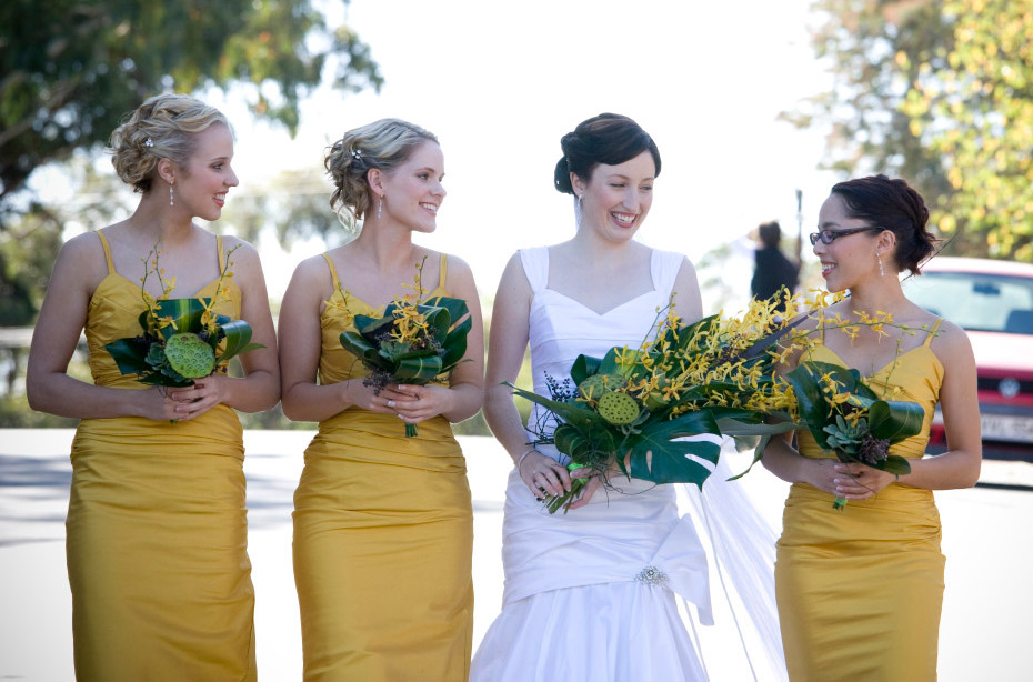 yellow orchids, succulents and tropical foliage arm sheaf style bouquet