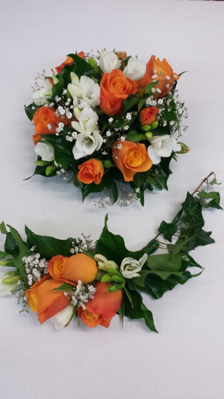 Cake top and base featuring orange roses, fressia and green orchids